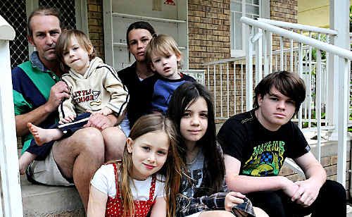 Wayne Wilson and partner Shanie Cahill (back), with sons Ethan and Liam, need assistance in finding suitable accommodation for their family which also includes foster kids Paige, Maddison and Jai Cahill (front). Wayne Wilson and partner Shanie Cahill (back), with sons Ethan and Liam, need assistance in finding suitable accommodation for their family which also includes foster kids Paige, Maddison and Jai Cahill (front).